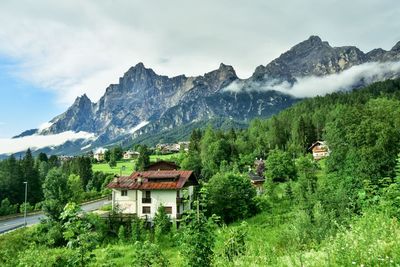 Houses on mountain against sky