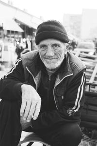 Senior man wearing knit hat looking away