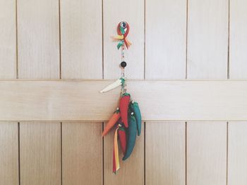 Close-up of chili peppers hanging on door