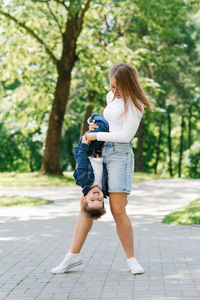 Family weekend in summer in the park for a walk. happy mom and son having fun