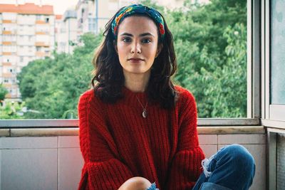 Portrait of young woman sitting outdoors