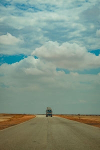Wide shot of a bus on a country road in sudan