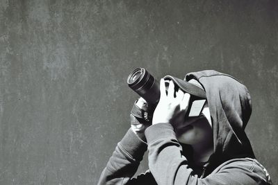 Close-up of man looking through binoculars 