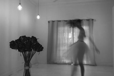 Blurred motion of woman dancing in home