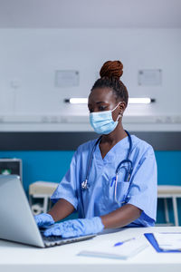 Female doctor using laptop in clinic