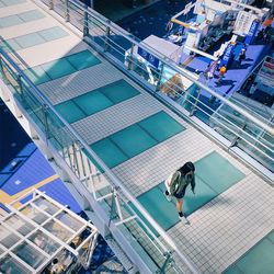 High angle view of woman walking on footbridge