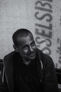 Portrait of man standing against wall