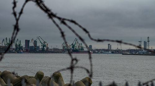 Pier at harbor against sky