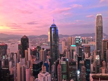 Skyscrapers in city against sky during sunset