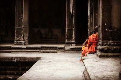 Monks sitting outside temple