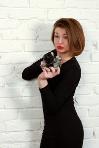 Beautiful woman standing against wall