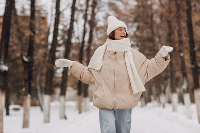 Rear view of woman standing on snow