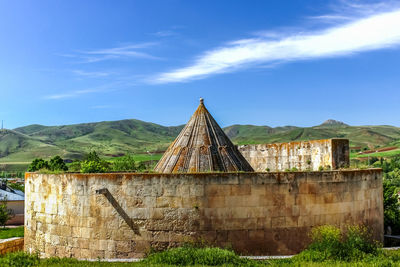 Old building on field against sky