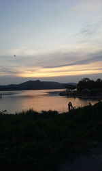 Scenic view of lake against sky during sunset