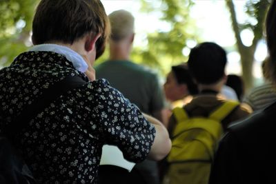 Rear view of couple standing against blurred background