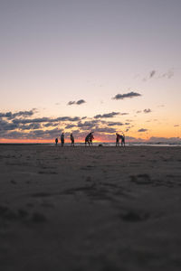 Group of silhouette people on beach