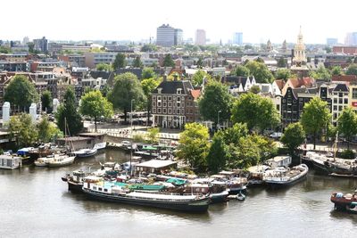 Boats in river with buildings in background