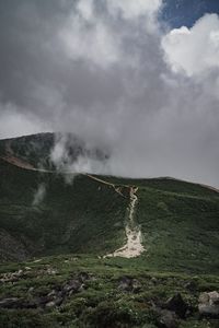 Scenic view of waterfall against sky