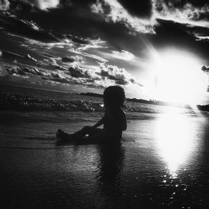 Silhouette of woman standing on beach