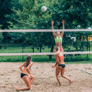 Young women playing beach volleyball