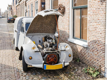 Cars on street against building