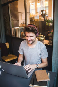 Confident businessman using laptop at desk in office