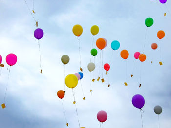 Low angle view of balloons against sky