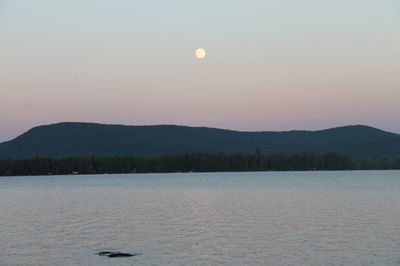 Scenic view of lake against sky at sunset