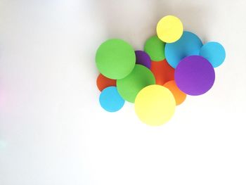 Close-up of colorful object over white background