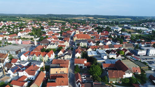 High angle view of houses in town against sky