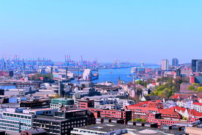 High angle view of buildings against blue sky