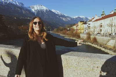 Portrait of woman standing on bridge