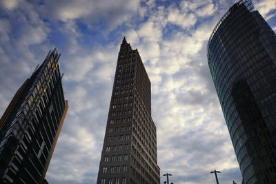 Low angle view of buildings against cloudy sky
