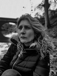 Mature woman looking away outdoors during winter