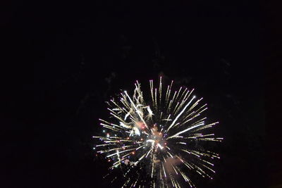 Low angle view of firework display at night