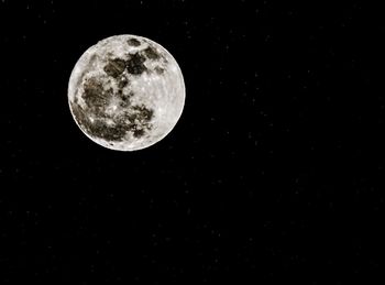 Low angle view of moon against sky at night