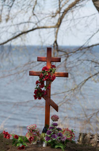 Close-up of cross in cemetery against sky