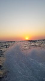 Scenic view of sea against clear sky during sunset