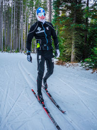 Full length of man skiing on snow covered landscape