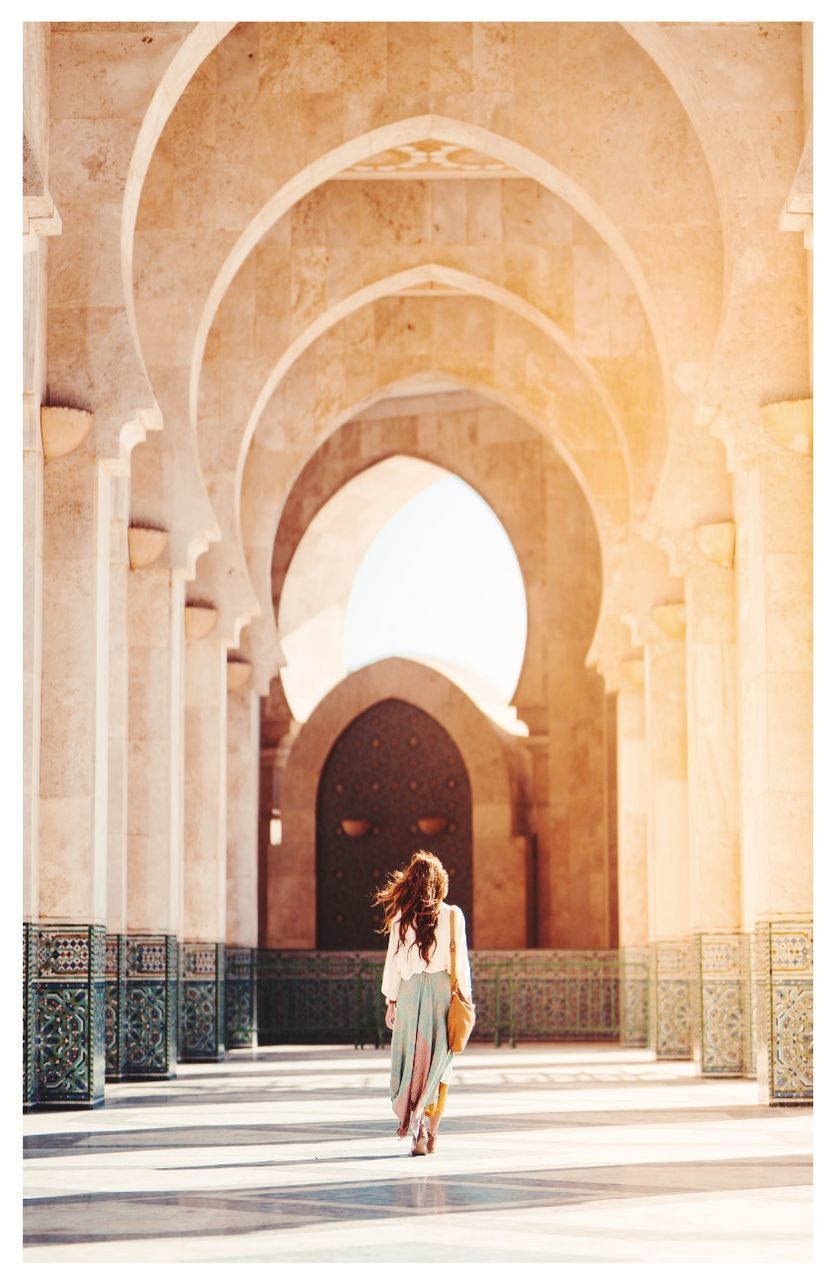 FULL LENGTH REAR VIEW OF WOMAN STANDING IN BUILDING