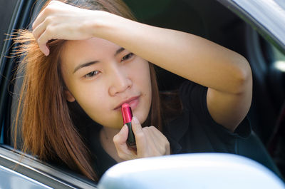 Close-up portrait of young woman in car