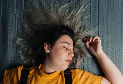 Directly above shot of girl sleeping on bed