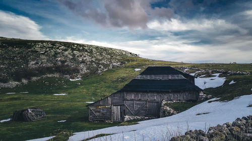 Panoramic view of building and mountains against sky