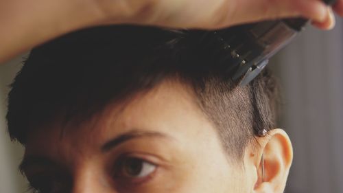 Close-up of women cutting hair