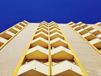 Geometric architecture of hotel facade photographed from below