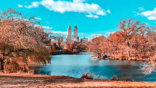 Scenic view of central park and towers in background 