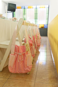 Pink bags on tiled floor in room