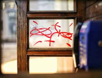 Close-up of text on glass window