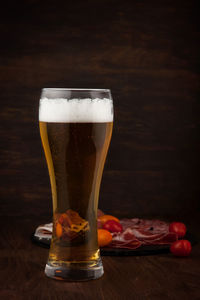 Close-up of beer glass on table