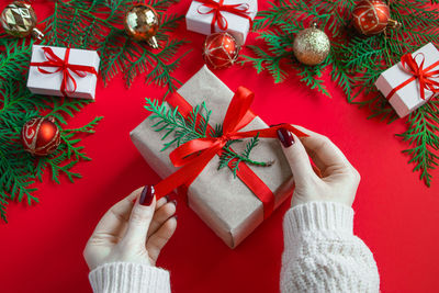 Midsection of woman holding christmas presents